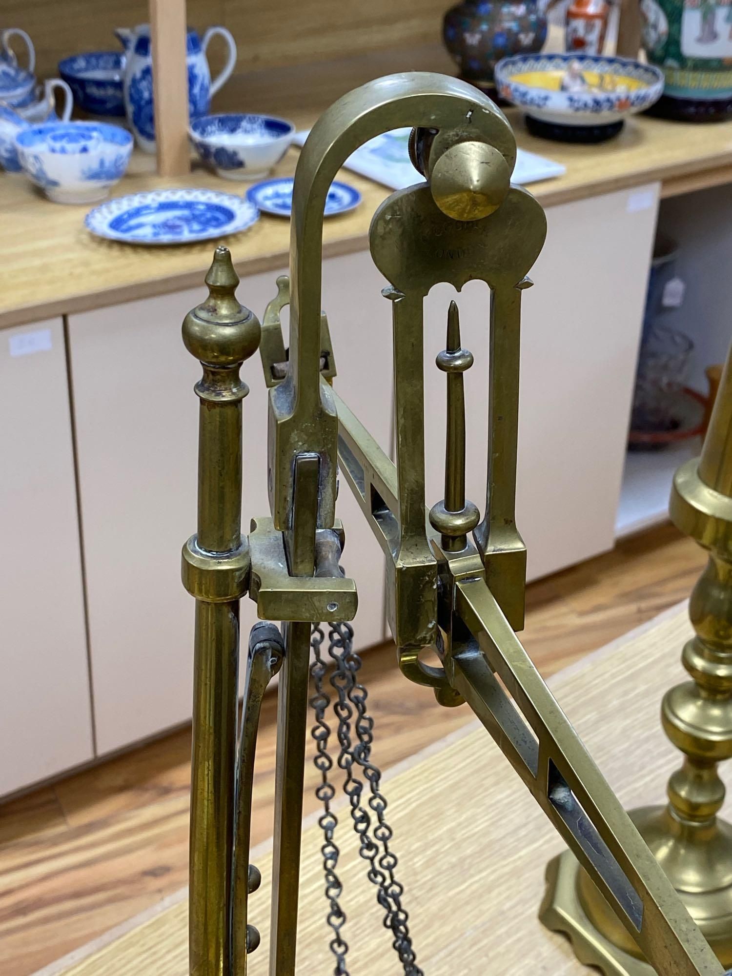 A pair of brass altar candlesticks, 60cm and a pair of Beam scales to weight 2lb, height 56cm